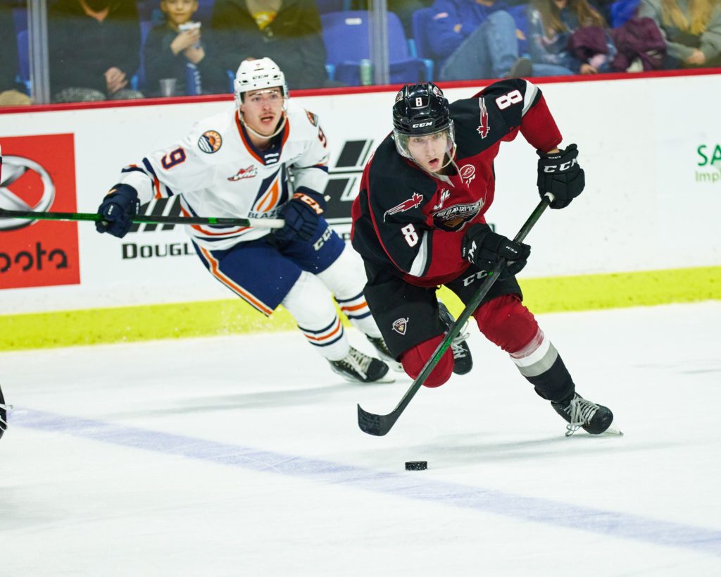Vancouver's Ty Thorpe chasing the puck against a Blazers player